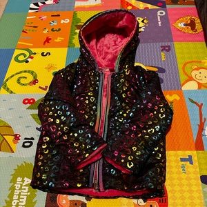 Colorful black jacket with metallic accents.